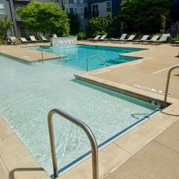 a swimming pool with lounge chairs