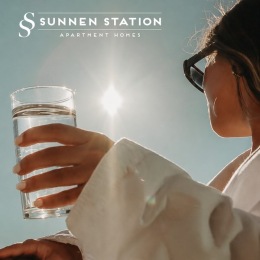 a woman holding a glass of water