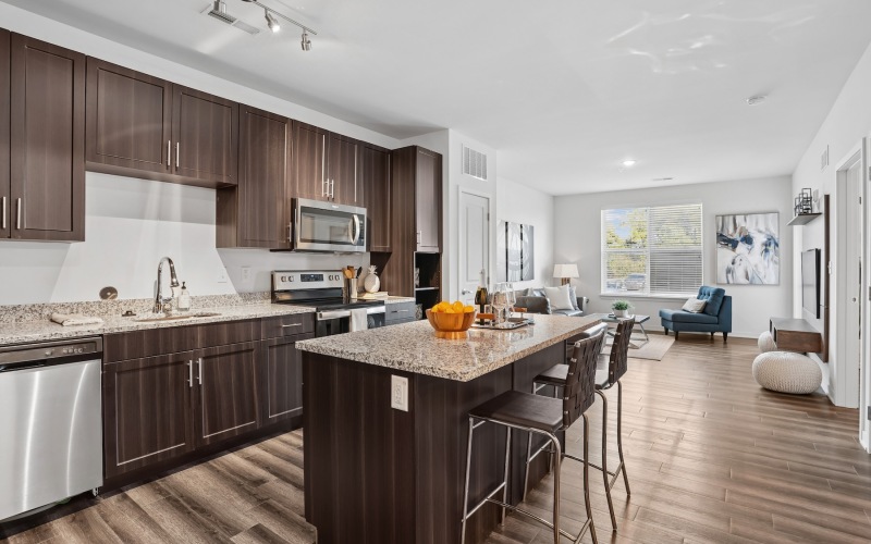 a kitchen with an island and chairs
