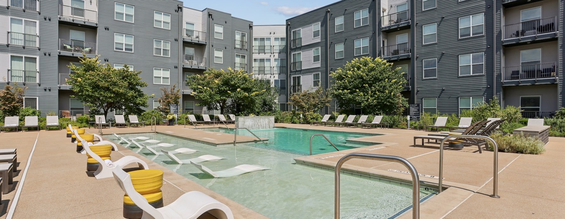 a swimming pool with lounge chairs