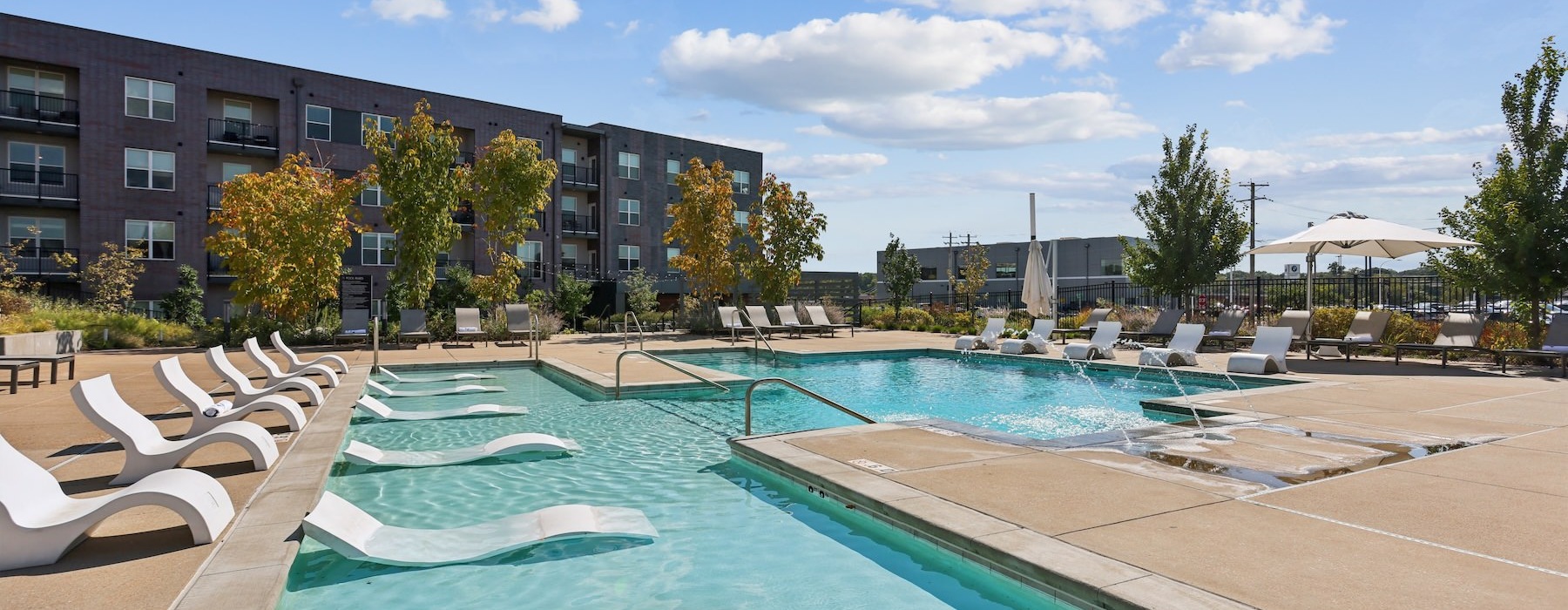a swimming pool with lounge chairs