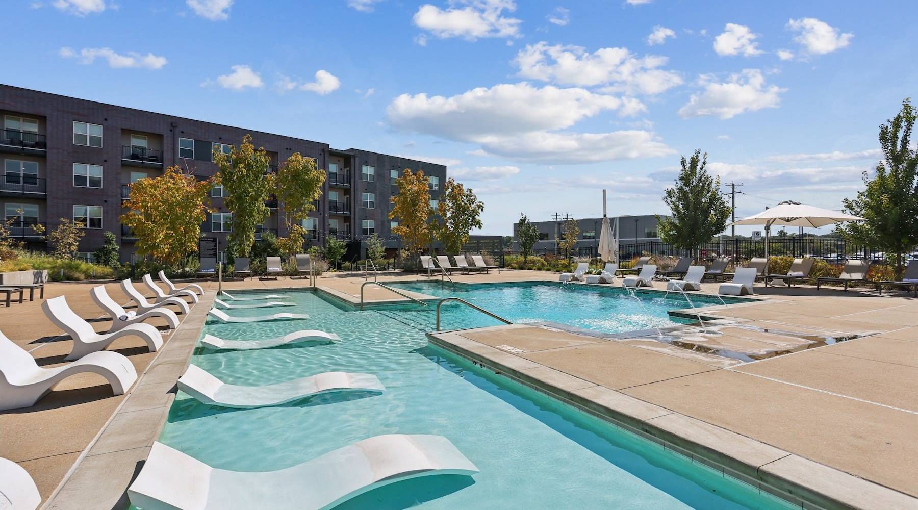 a swimming pool with lounge chairs