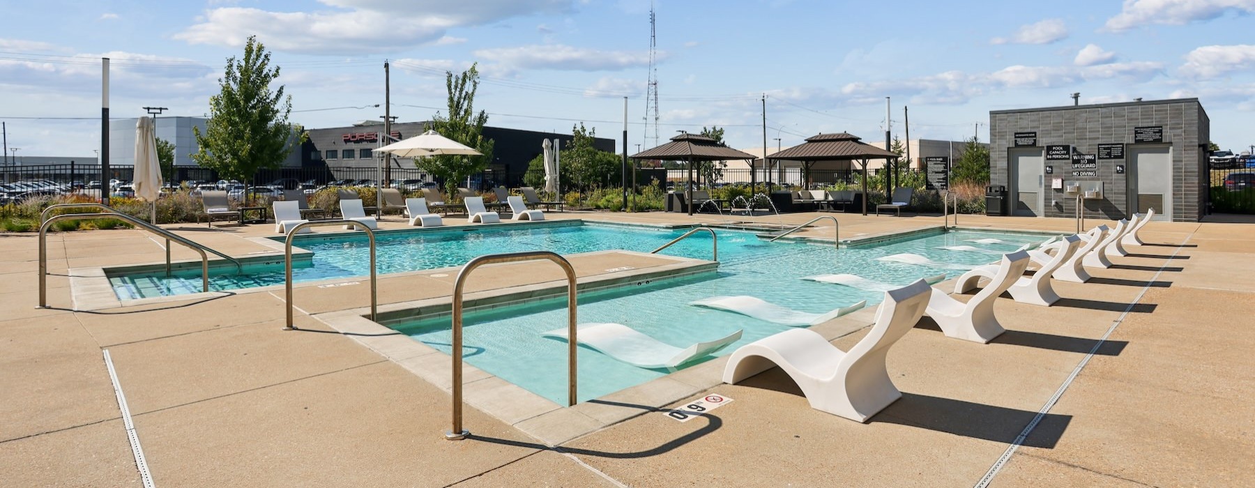a swimming pool with lounge chairs
