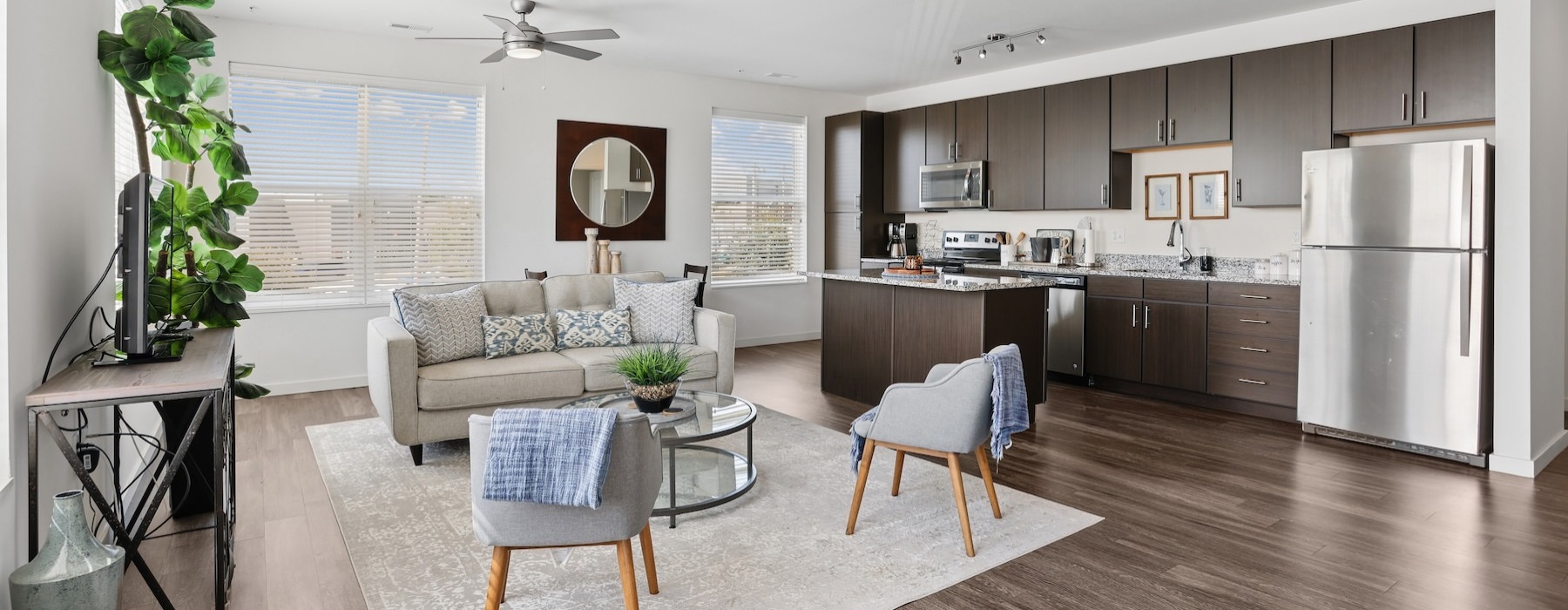 a living room with a couch, tables and chairs