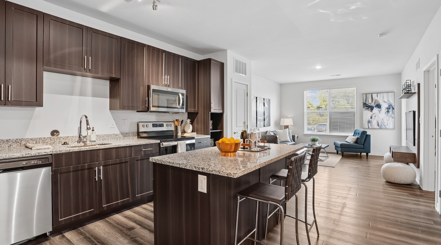 a kitchen with an island and chairs