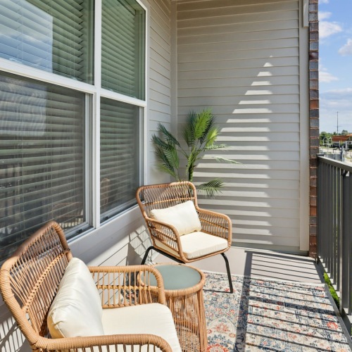 a balcony with a table and chairs