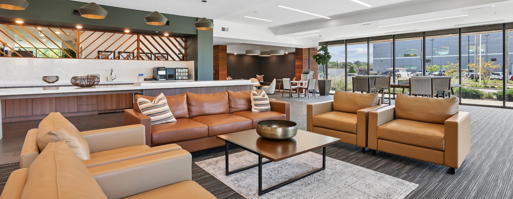 a clubroom with a couch, tables and chairs